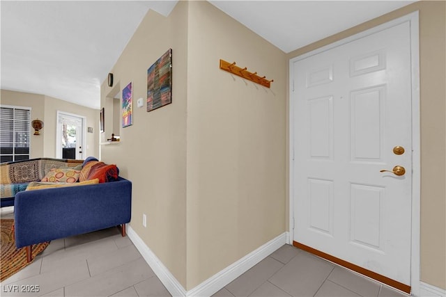 entrance foyer featuring baseboards and light tile patterned floors