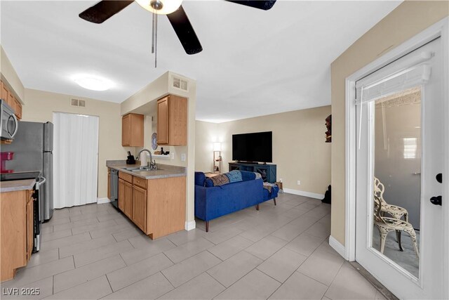kitchen with stainless steel microwave, visible vents, dishwashing machine, light countertops, and open floor plan