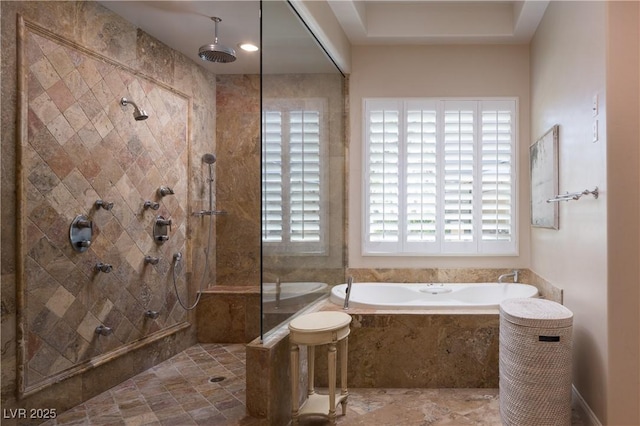 bathroom featuring a tile shower and a bath