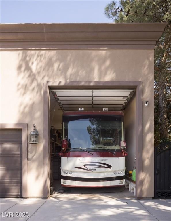 garage featuring concrete driveway