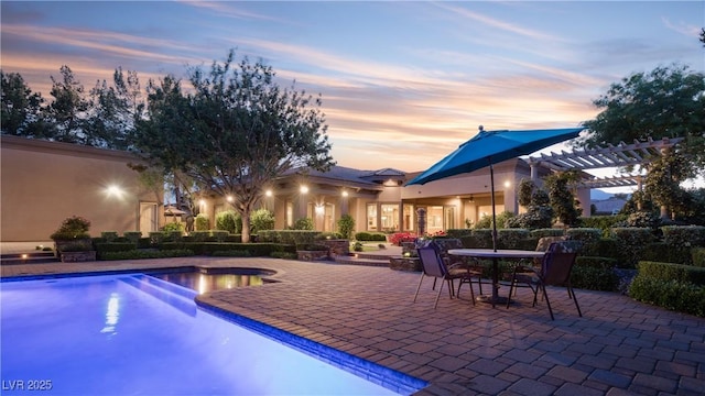 outdoor pool with outdoor dining space, a patio area, and a pergola