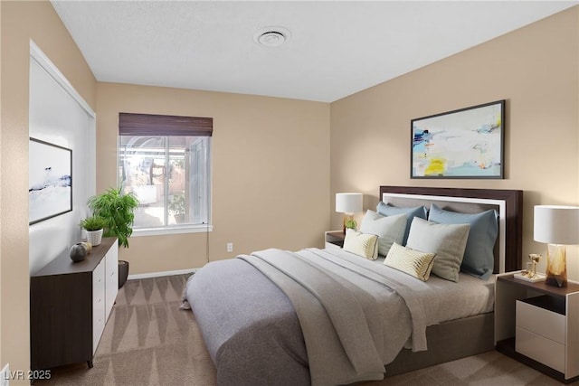 bedroom featuring baseboards, carpet, and visible vents
