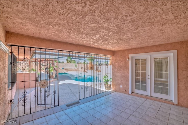 exterior space featuring french doors, fence, and a patio