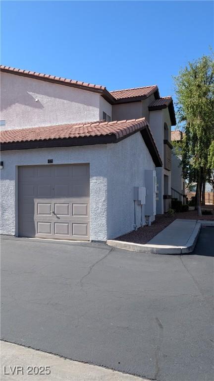 2615 W Gary Ave Unit 2013, Las Vegas, NV 89123 - view of side of property with stucco siding and an attached garage