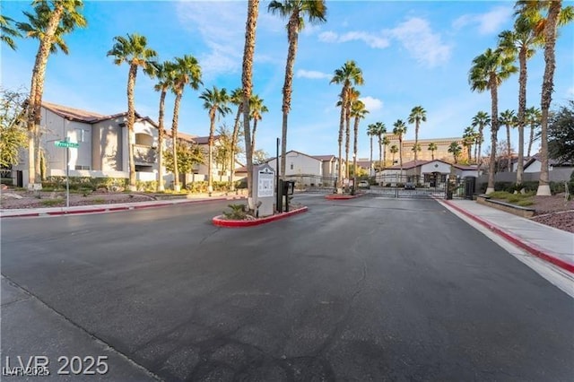2615 W Gary Ave Unit 2013, Las Vegas, NV 89123 - view of asphalt street featuring sidewalks, a residential view, curbs, a gate, and a gated entry