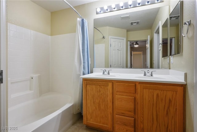 full bathroom with tile patterned floors, a sink, shower / tub combo with curtain, and visible vents