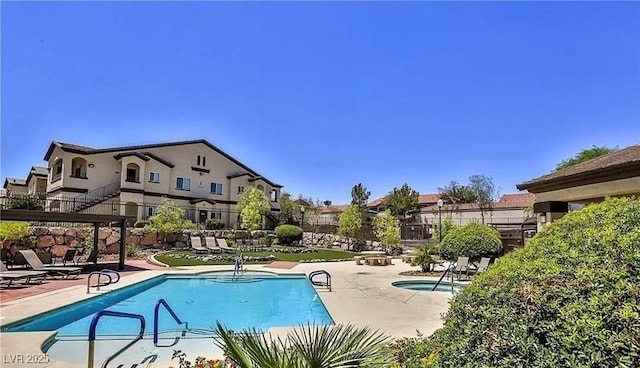 pool featuring a residential view, a patio, and fence