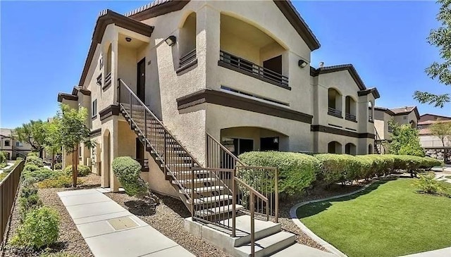 view of property featuring stairs and fence
