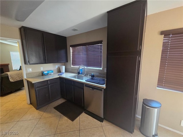 7328 Coffeyville Ave, Las Vegas, NV 89147 - kitchen featuring light tile patterned floors, stainless steel dishwasher, light countertops, and a sink