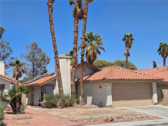 7328 Coffeyville Ave, Las Vegas, NV 89147 - mediterranean / spanish home featuring stucco siding, a tiled roof, and a garage
