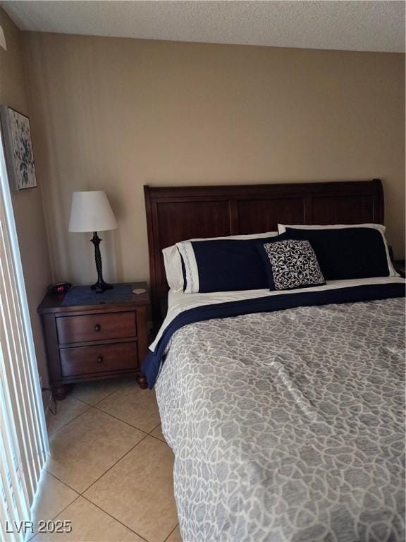 7328 Coffeyville Ave, Las Vegas, NV 89147 - bedroom with light tile patterned floors and a textured ceiling