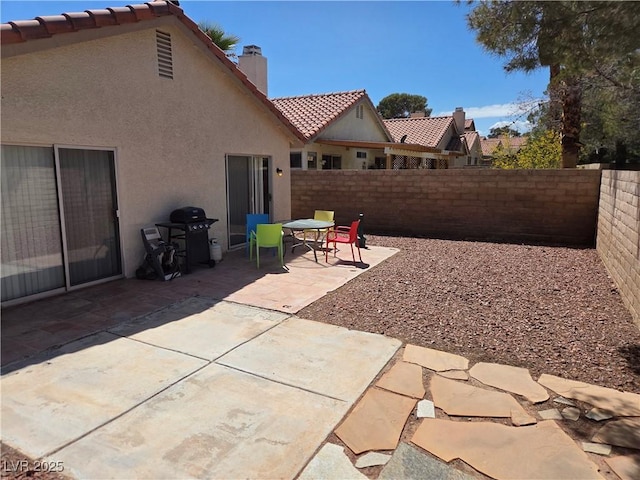 7328 Coffeyville Ave, Las Vegas, NV 89147 - view of patio with a grill and a fenced backyard