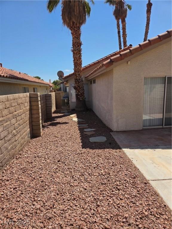 7328 Coffeyville Ave, Las Vegas, NV 89147 - view of yard featuring fence, a gate, and a patio area