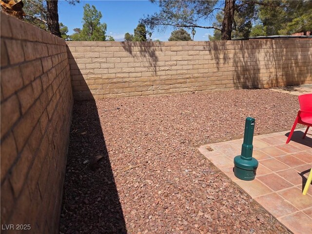 7328 Coffeyville Ave, Las Vegas, NV 89147 - view of yard featuring a patio and a fenced backyard