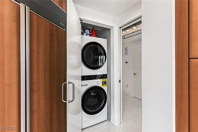 2857 Paradise Rd Unit 305, Las Vegas, NV 89109 - laundry room with stacked washer and clothes dryer and light tile patterned floors