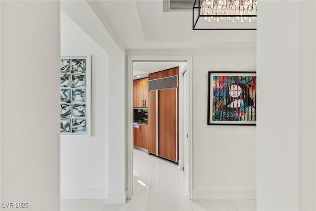 2857 Paradise Rd Unit 305, Las Vegas, NV 89109 - corridor featuring baseboards, light tile patterned flooring, and a chandelier