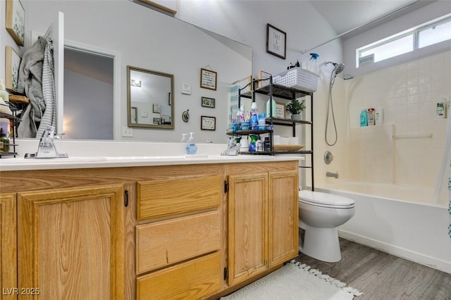 full bath with toilet, vanity, tub / shower combination, and wood finished floors