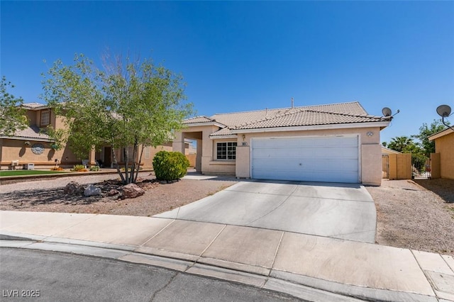 ranch-style home featuring driveway, a tiled roof, and stucco siding