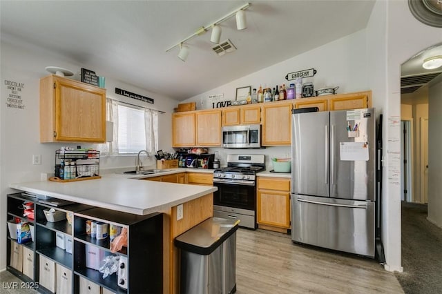 kitchen with a sink, light brown cabinets, rail lighting, visible vents, and appliances with stainless steel finishes