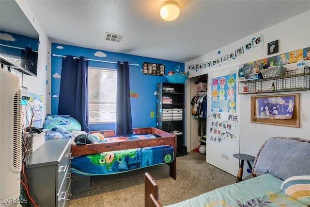 bedroom with visible vents, a closet, and carpet floors