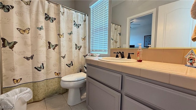 bathroom featuring toilet, tile patterned flooring, and vanity