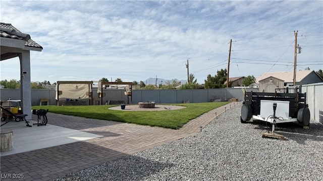 view of yard with a patio, a fire pit, and fence