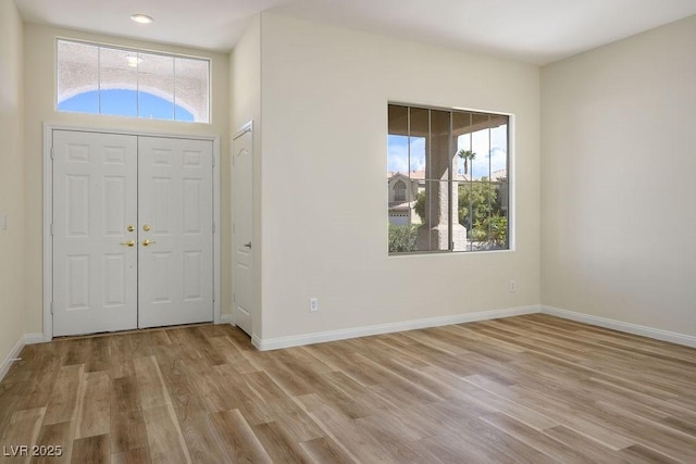10657 Sapphire Vista Ave, Las Vegas, NV 89144 - foyer entrance featuring light wood finished floors, a wealth of natural light, and baseboards