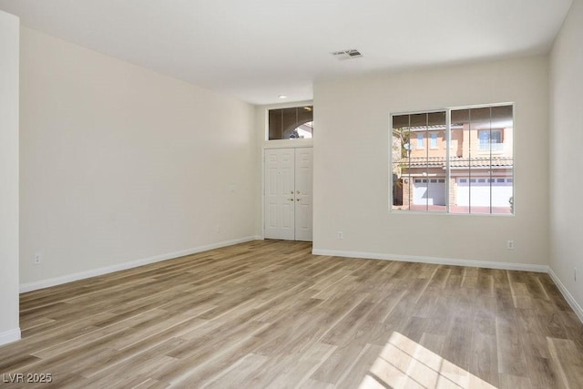 10657 Sapphire Vista Ave, Las Vegas, NV 89144 - unfurnished room with visible vents, baseboards, and light wood-style floors