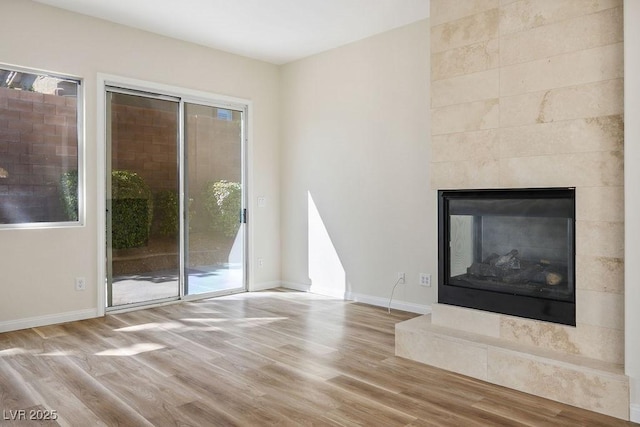 10657 Sapphire Vista Ave, Las Vegas, NV 89144 - unfurnished living room with a wealth of natural light, wood finished floors, and baseboards