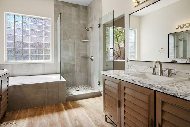10657 Sapphire Vista Ave, Las Vegas, NV 89144 - full bathroom with a garden tub, a shower stall, wood finished floors, and vanity