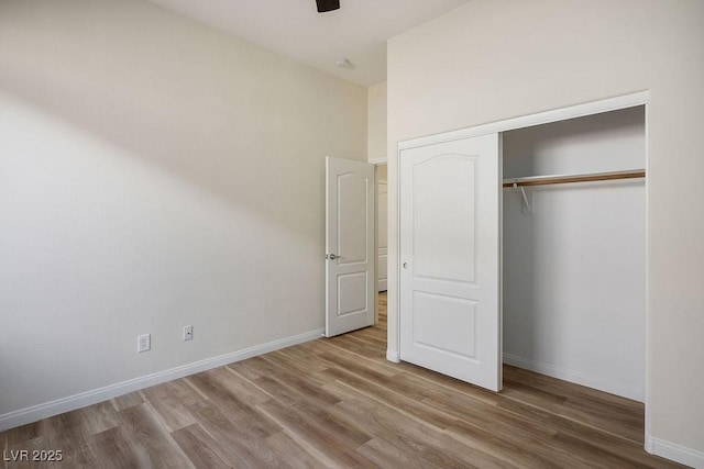 10657 Sapphire Vista Ave, Las Vegas, NV 89144 - unfurnished bedroom with wood finished floors, a closet, a ceiling fan, and baseboards