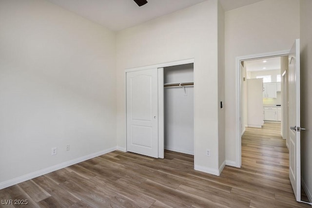 10657 Sapphire Vista Ave, Las Vegas, NV 89144 - unfurnished bedroom with baseboards, wood finished floors, and a closet