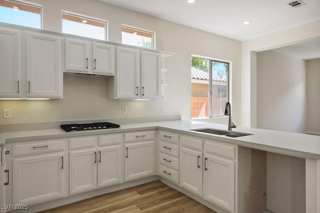 10657 Sapphire Vista Ave, Las Vegas, NV 89144 - kitchen with visible vents, light countertops, gas stovetop, and a sink