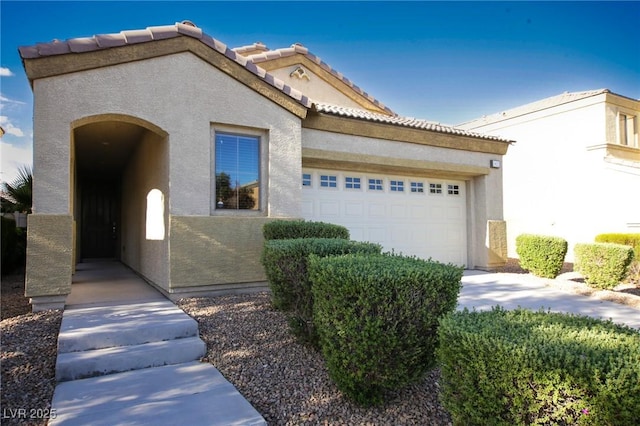 3652 Remington Grove Ave, North Las Vegas, NV 89081 - mediterranean / spanish home featuring stucco siding, a tiled roof, and an attached garage