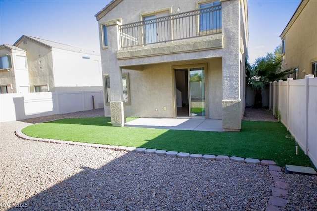 3652 Remington Grove Ave, North Las Vegas, NV 89081 - rear view of house featuring a patio, stucco siding, a fenced backyard, and a balcony