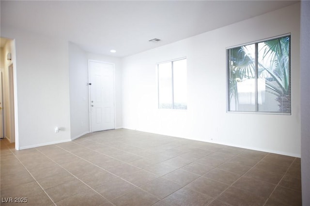 3652 Remington Grove Ave, North Las Vegas, NV 89081 - tiled spare room featuring recessed lighting, visible vents, a wealth of natural light, and baseboards