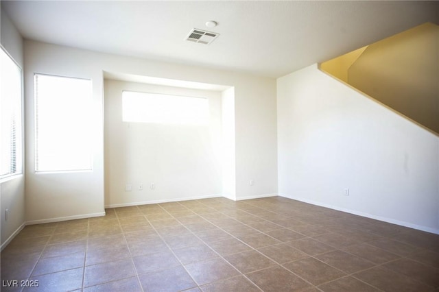 3652 Remington Grove Ave, North Las Vegas, NV 89081 - spare room with visible vents, plenty of natural light, tile patterned flooring, and baseboards