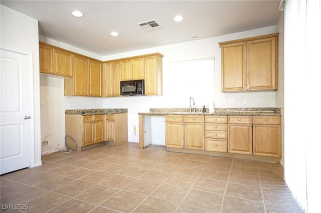 3652 Remington Grove Ave, North Las Vegas, NV 89081 - kitchen with recessed lighting, a sink, black microwave, visible vents, and light stone counters