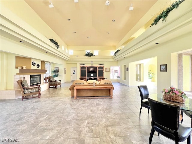 8070 W Russell Rd Unit 2070, Las Vegas, NV 89113 - living room featuring a glass covered fireplace, a healthy amount of sunlight, and a tray ceiling