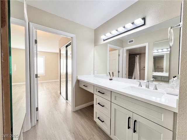 8070 W Russell Rd Unit 2070, Las Vegas, NV 89113 - bathroom featuring wood finished floors, visible vents, vanity, and baseboards