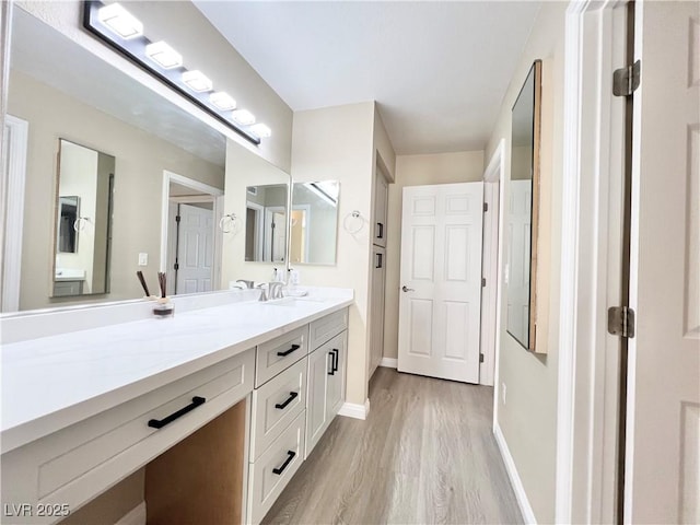 8070 W Russell Rd Unit 2070, Las Vegas, NV 89113 - bathroom with vanity, wood finished floors, and baseboards