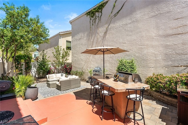 view of patio with outdoor dry bar, an outdoor living space, a grill, and fence