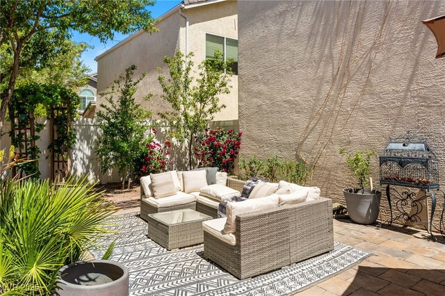 view of patio / terrace featuring outdoor lounge area and fence