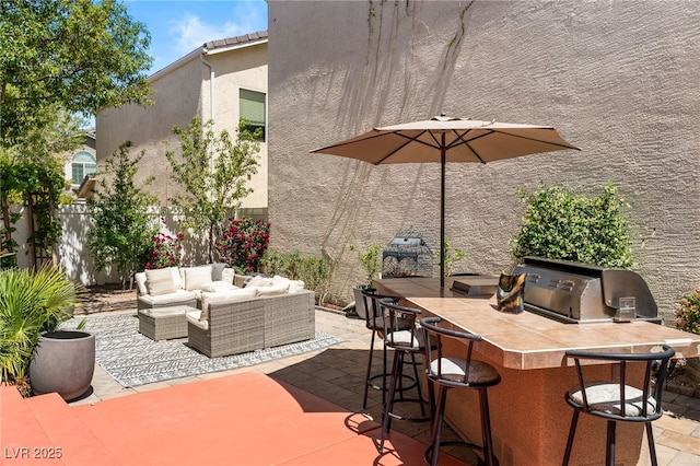 view of patio / terrace featuring fence, a grill, outdoor wet bar, and an outdoor hangout area