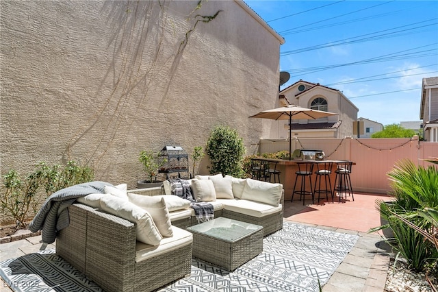 view of patio with fence, outdoor dry bar, and an outdoor living space