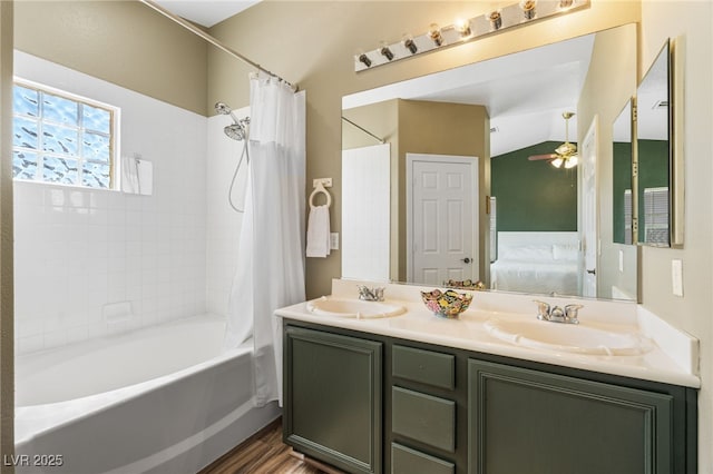 full bathroom with shower / bath combo with shower curtain, connected bathroom, double vanity, and a sink