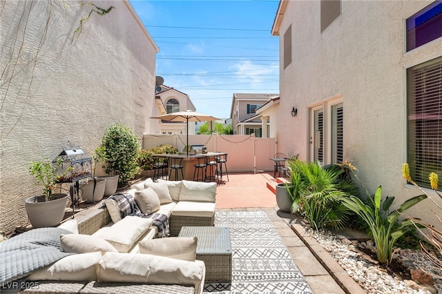 view of patio / terrace featuring an outdoor hangout area and fence