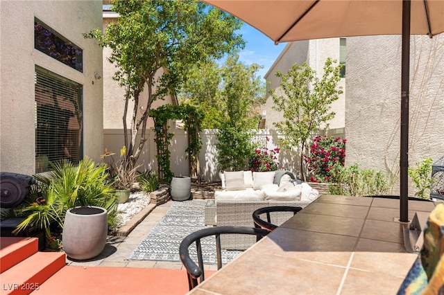 view of patio featuring fence and an outdoor living space