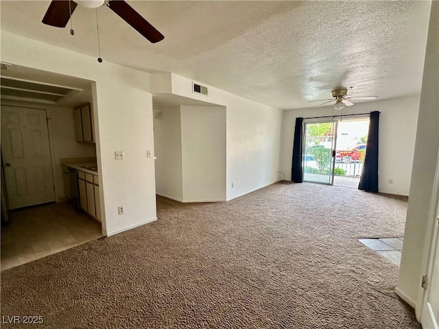 unfurnished living room featuring visible vents, a ceiling fan, and carpet flooring