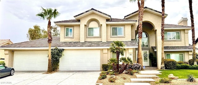 9905 Fox Springs Dr, Las Vegas, NV 89117 - view of front of home featuring concrete driveway, stucco siding, and a chimney